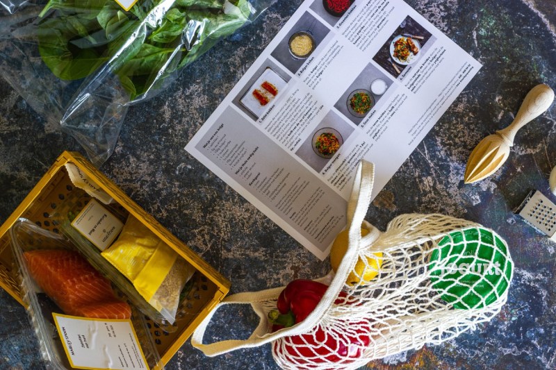meal kit recipe instruction card next to meal kit ingredients.
