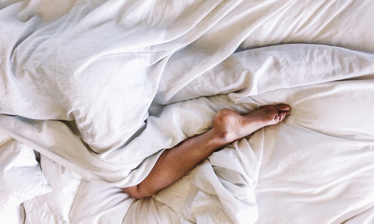 man resting in bed after relaxing soak.