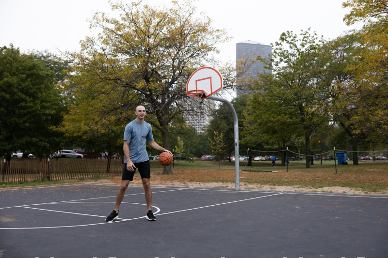 Chicago Bulls guard Alex Caruso sports TravisMathew's Active Heater Line on a playground basketball court.