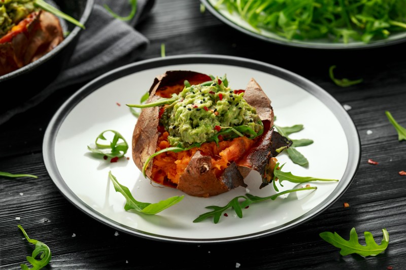 A baked sweet potato boat on a plate.
