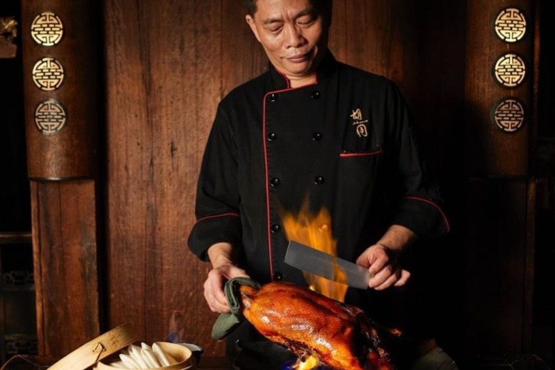 Hutong Flaming Peking Duck being prepared.