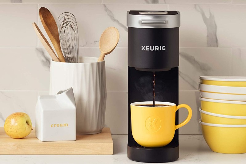 Keurig K-Mini coffee maker on a counter with accessories.