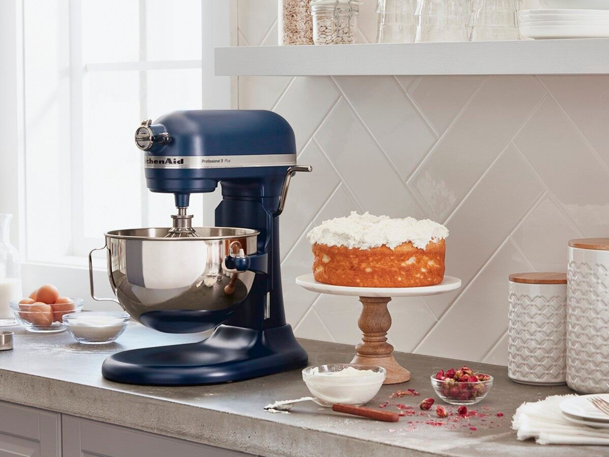 KitchenAid Pro 5 Plus 5-quart Bowl-Lift Stand Mixer sits next to a cake on a kitchen counter.