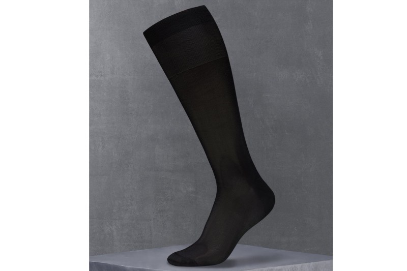 Mannequin leg and foot wearing a black sock.