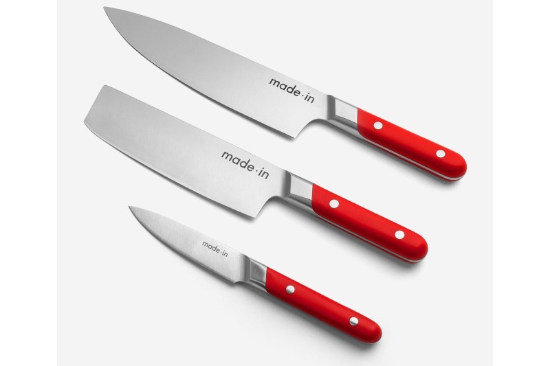 chef knife, nakiri knife, and a paring knife sitting on a counter.