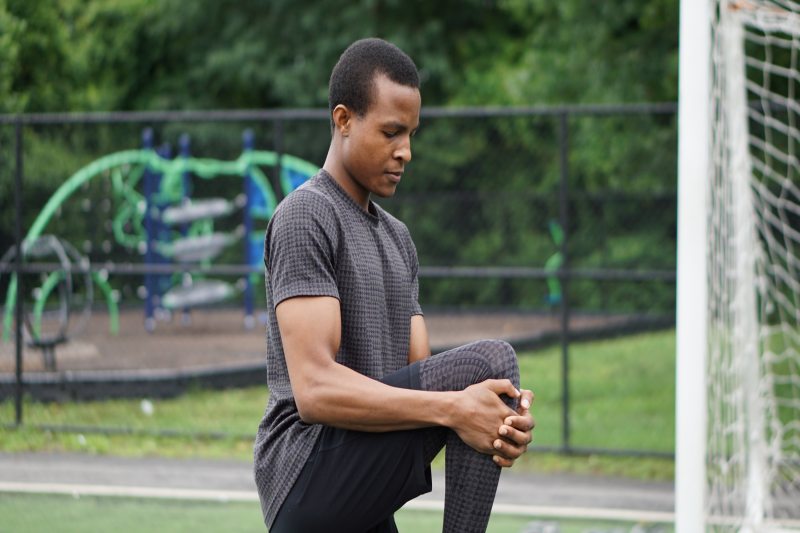 man stretching glutes