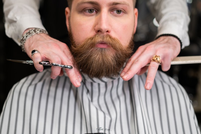 Man grooming and trimming his beard