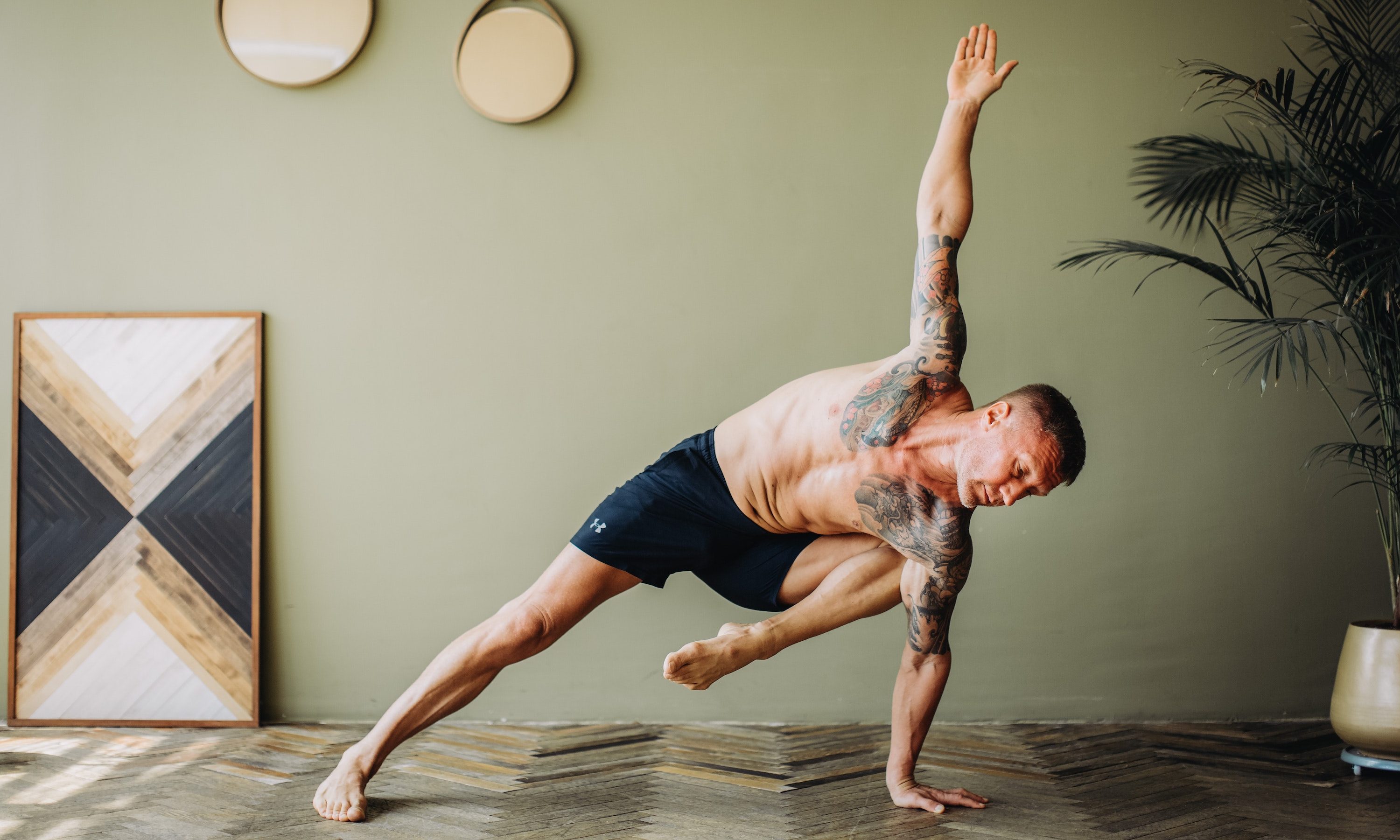 Man doing a side plank yoga pose.