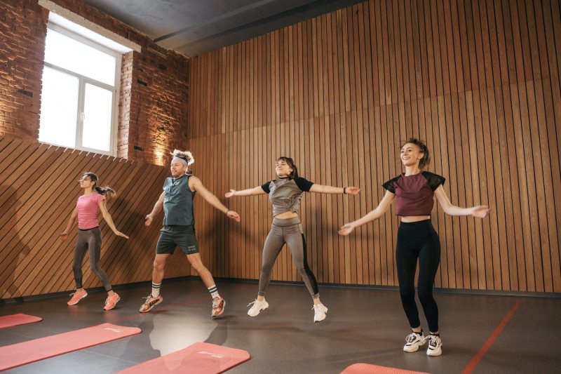 Exercise class doing jumping jacks.