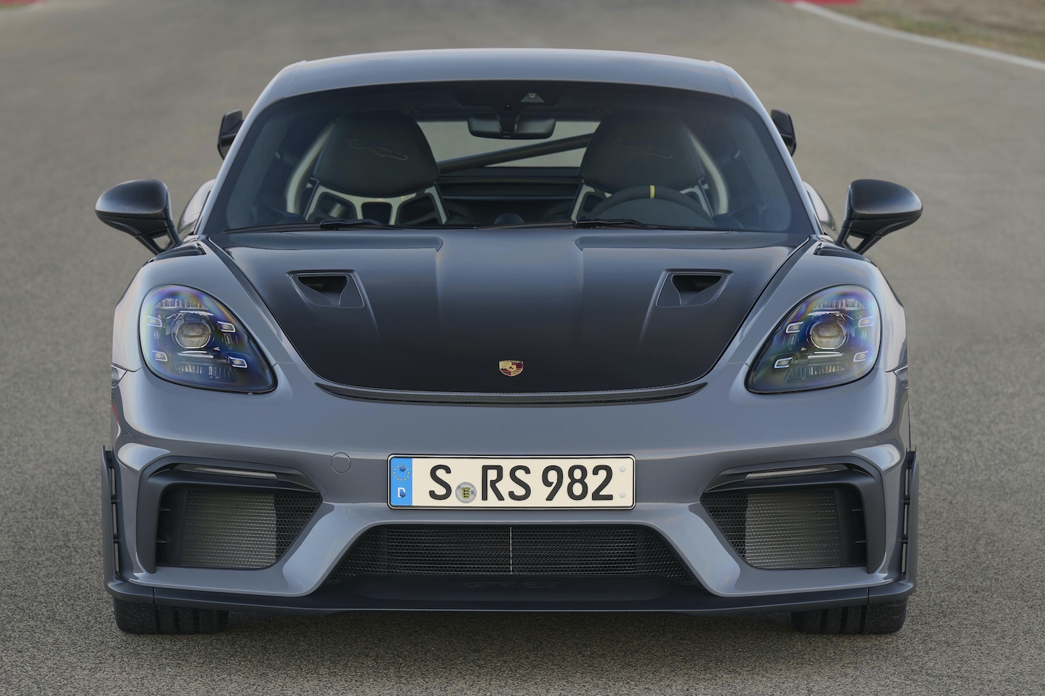 Porsche 718 Cayman GT4 RS front end close up on track.