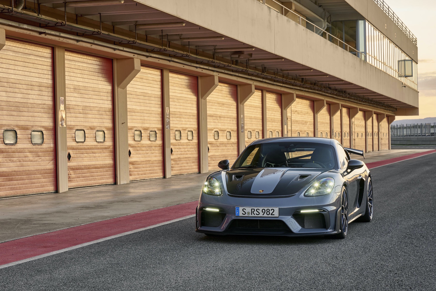 Porsche 718 Cayman GT4 RS in the pit lane front end from driver's side angle.