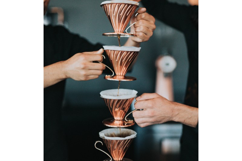 four Pour over coffees dripping into each other.