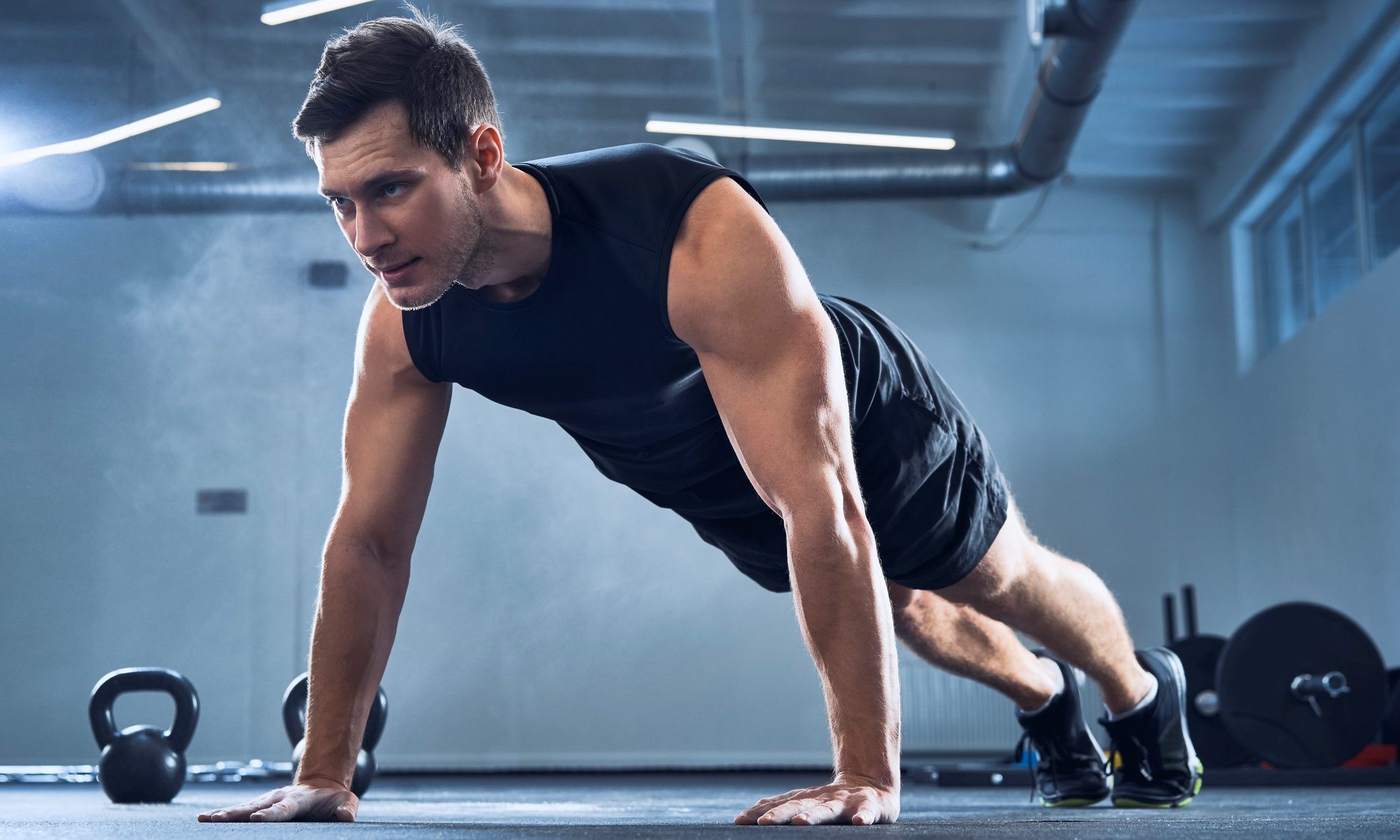Man doing push-ups at a gym.