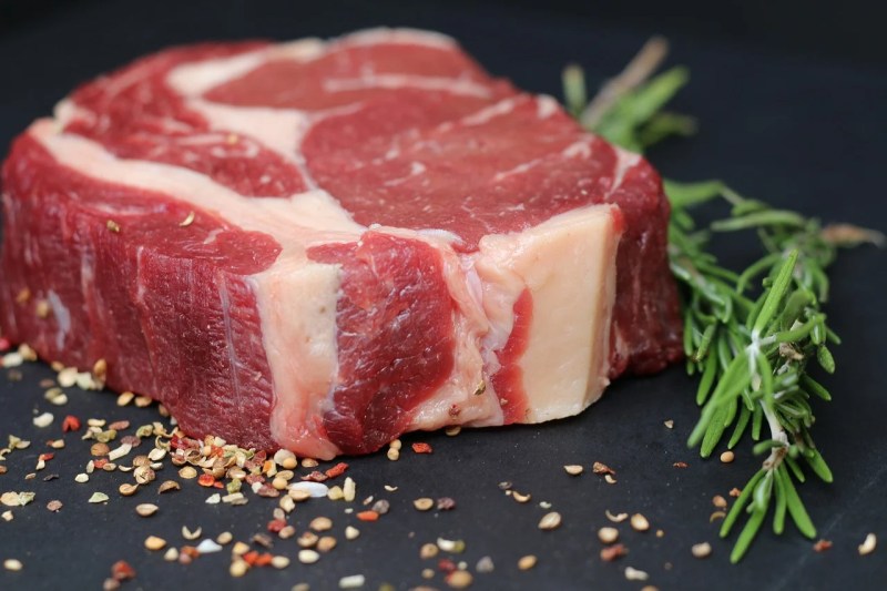 Red meat prepared with rosemary and ready to cook.