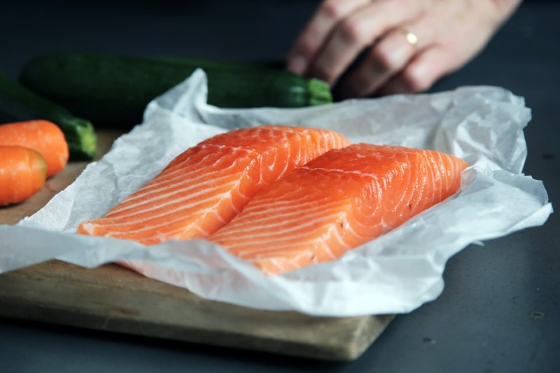 two salmon filets sitting on butcher paper.