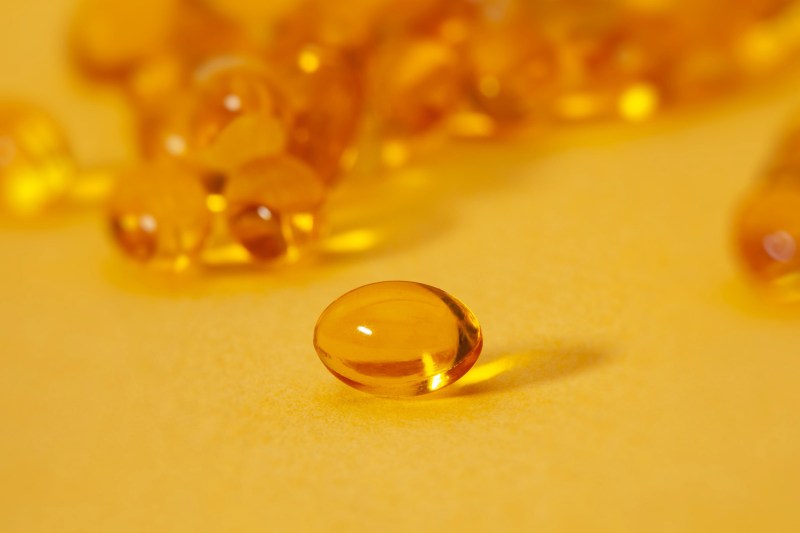 A closeup of a vitamin D capsule.