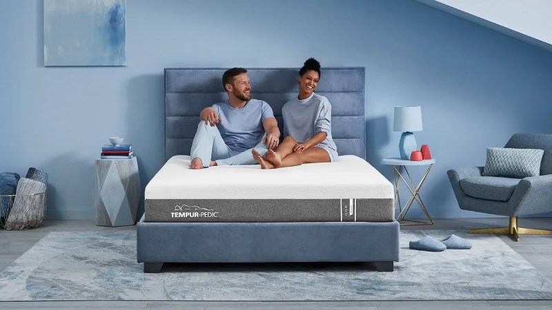 Tempur-Cloud mattress with couple sitting on the bed.