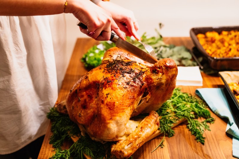 Turkey being carved on a cutting board.