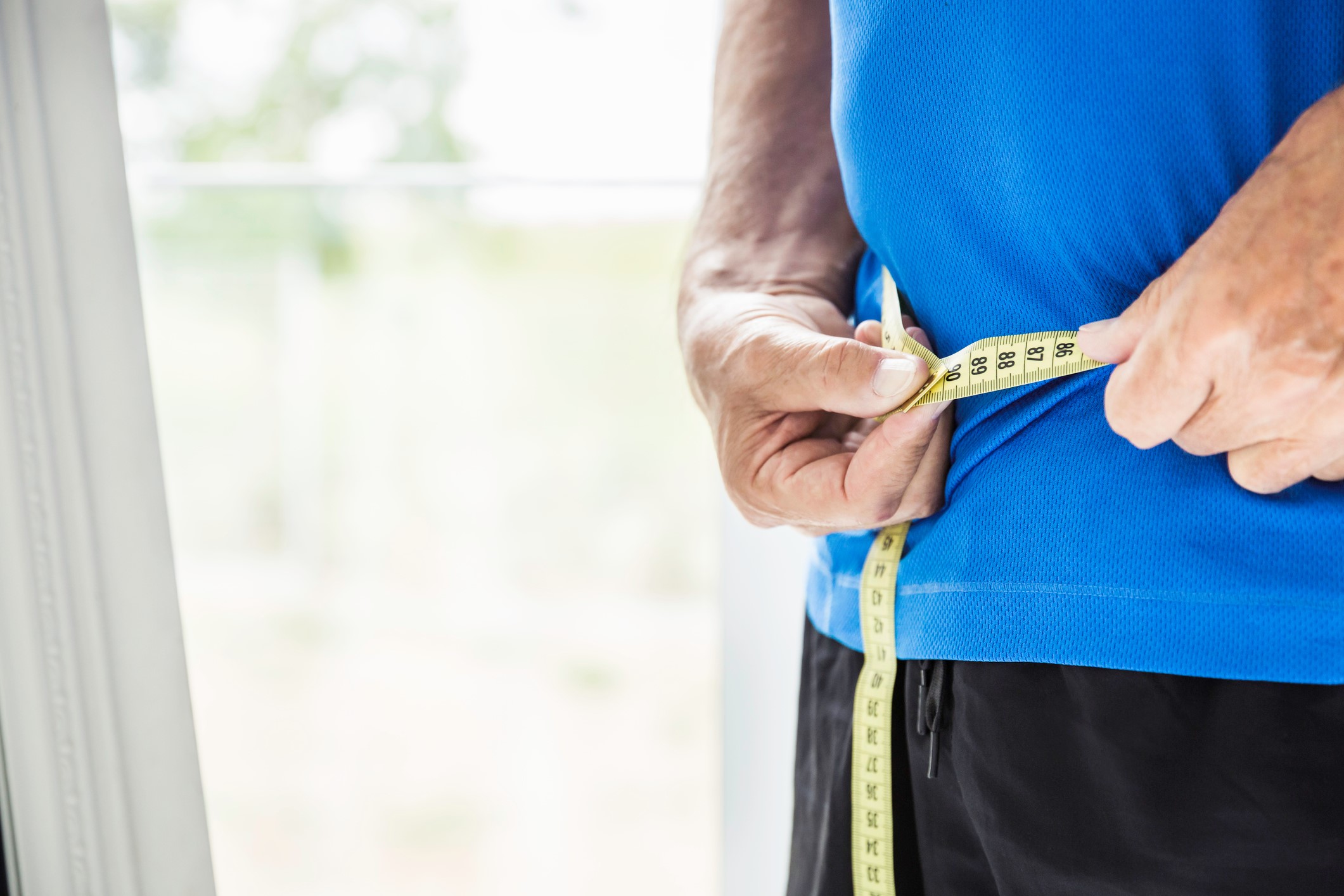 Person measuring waist