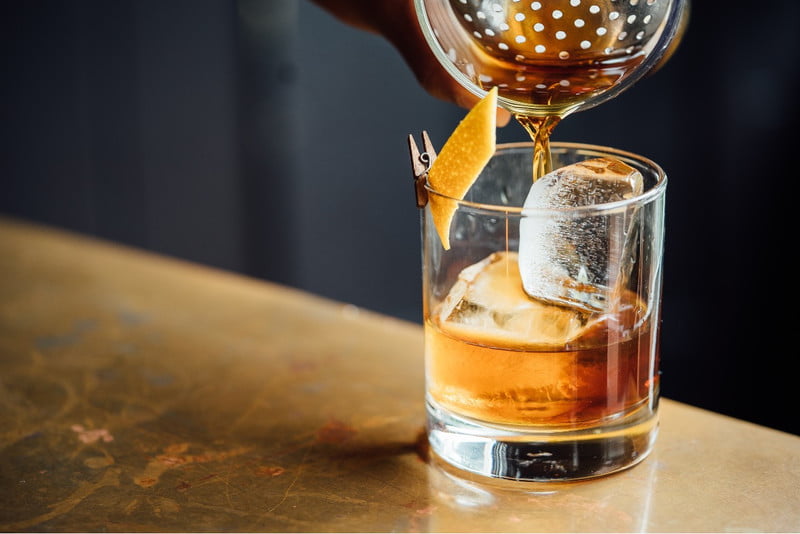 Whiskey being poured into a glass.