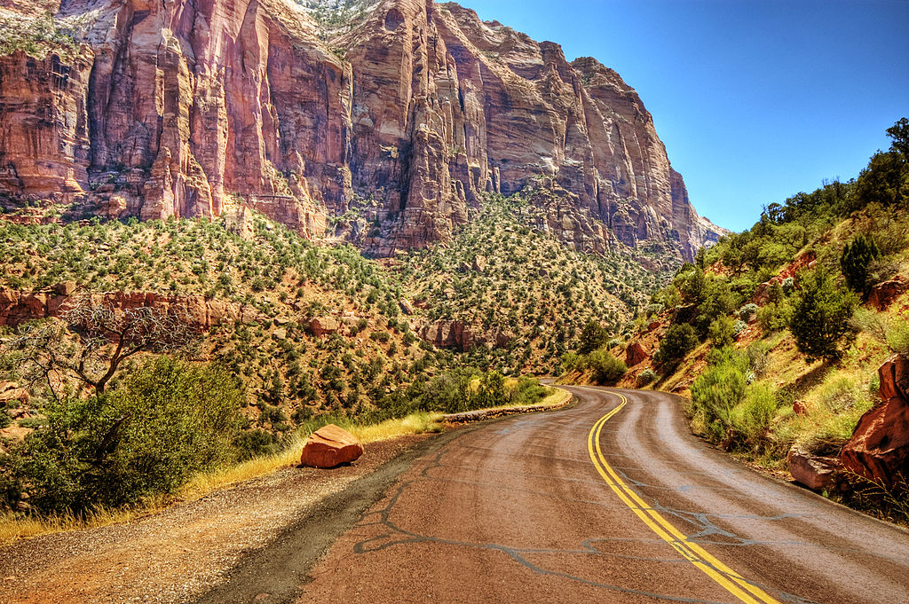 windy road going through the mountainous Zion National Park.