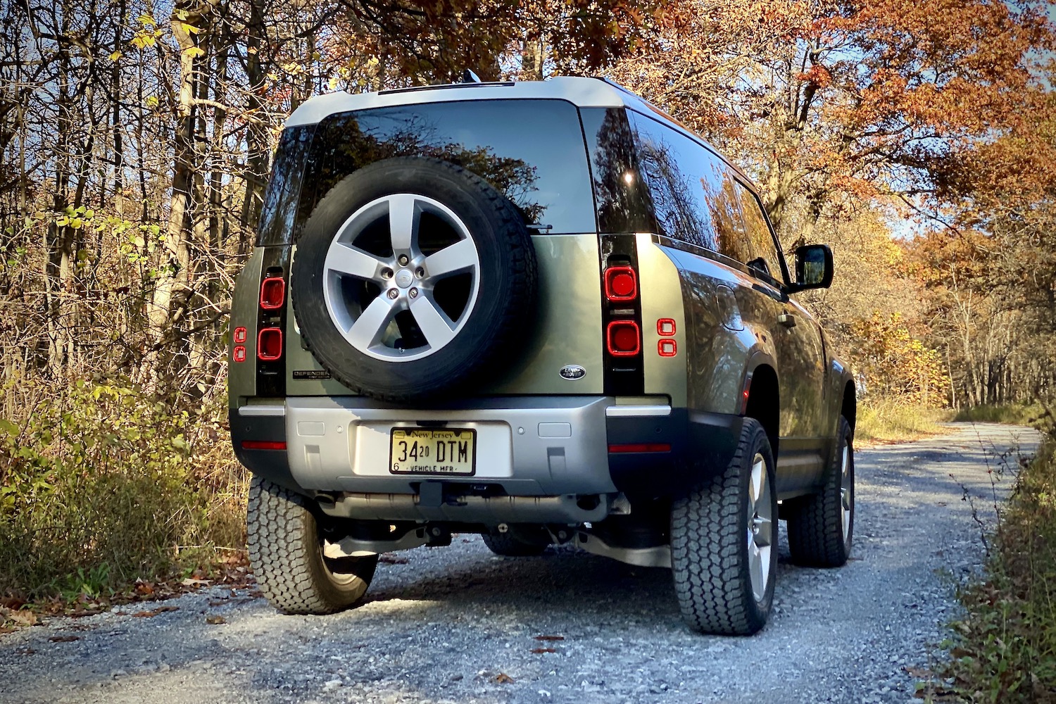 Land Rover Defender rear end close up on a gravel road.