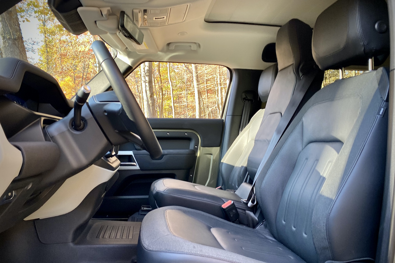 Front seats in Land Rover Defender from driver's side.