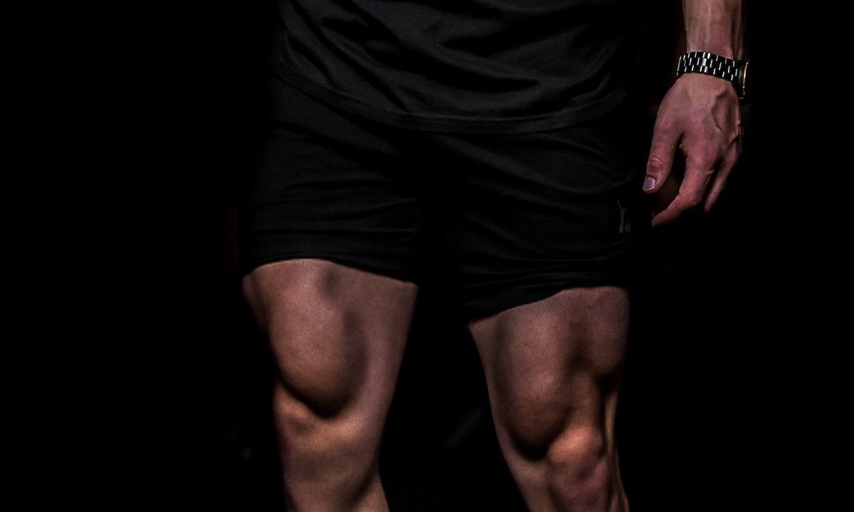 A close-up of a male athlete's quad muscles.