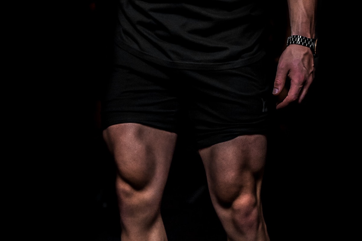 A close-up of a male athlete's quad muscles.