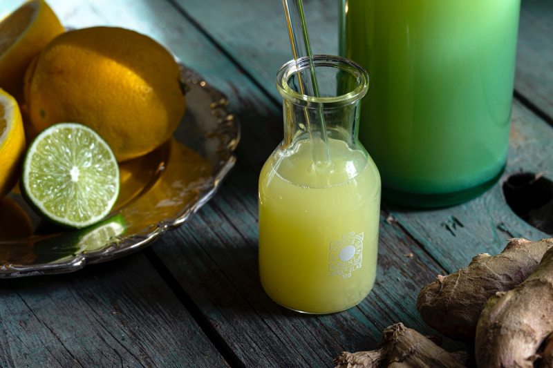 lemons and limes on a dish next to lemon-lime juice cleanse.