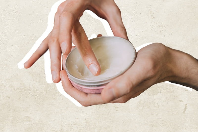 Pair of hands using beard balm