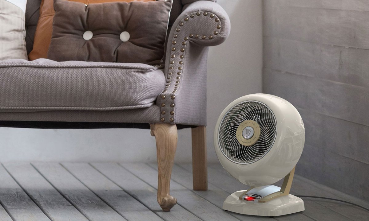 A space heater beside an armchair in a living room.