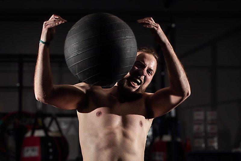 man catching medicine ball.