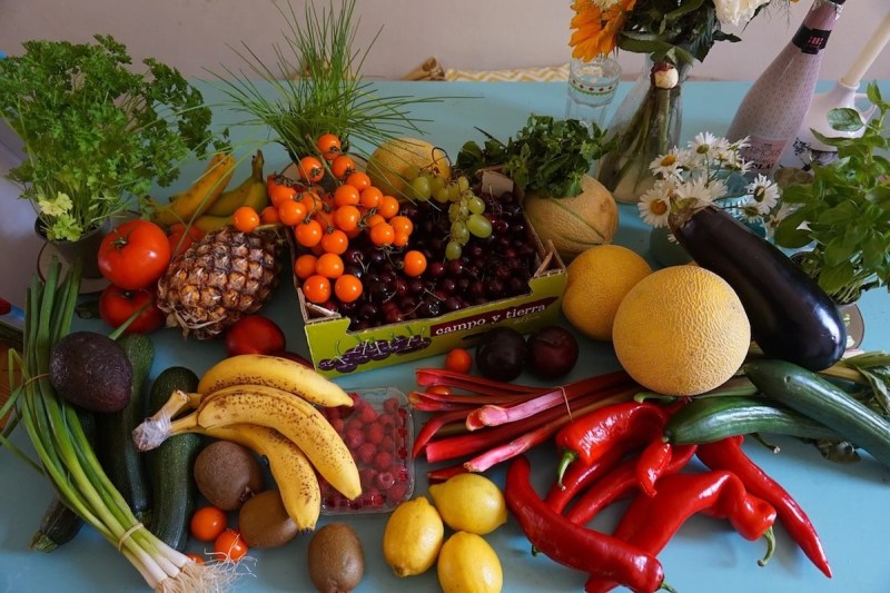 Bananas, peppers, tomatoes, and other produce on a table.