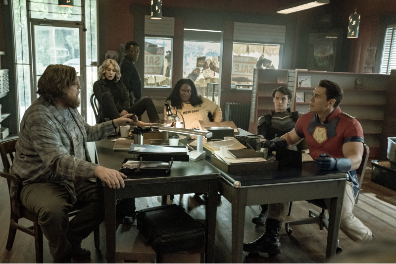 From left to right, Peacemaker's oddball gang: Economos (Steve Agee), Harcourt (Jennifer Holland), Murn (Chukwudi Iwuji), Adebayo (Danielle Brooks, Vigilante (Freddie Stroma), and Peacemaker (John Cena).