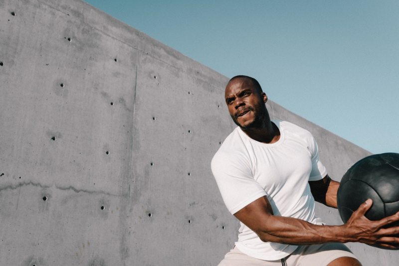 Man doing medicine ball slams.