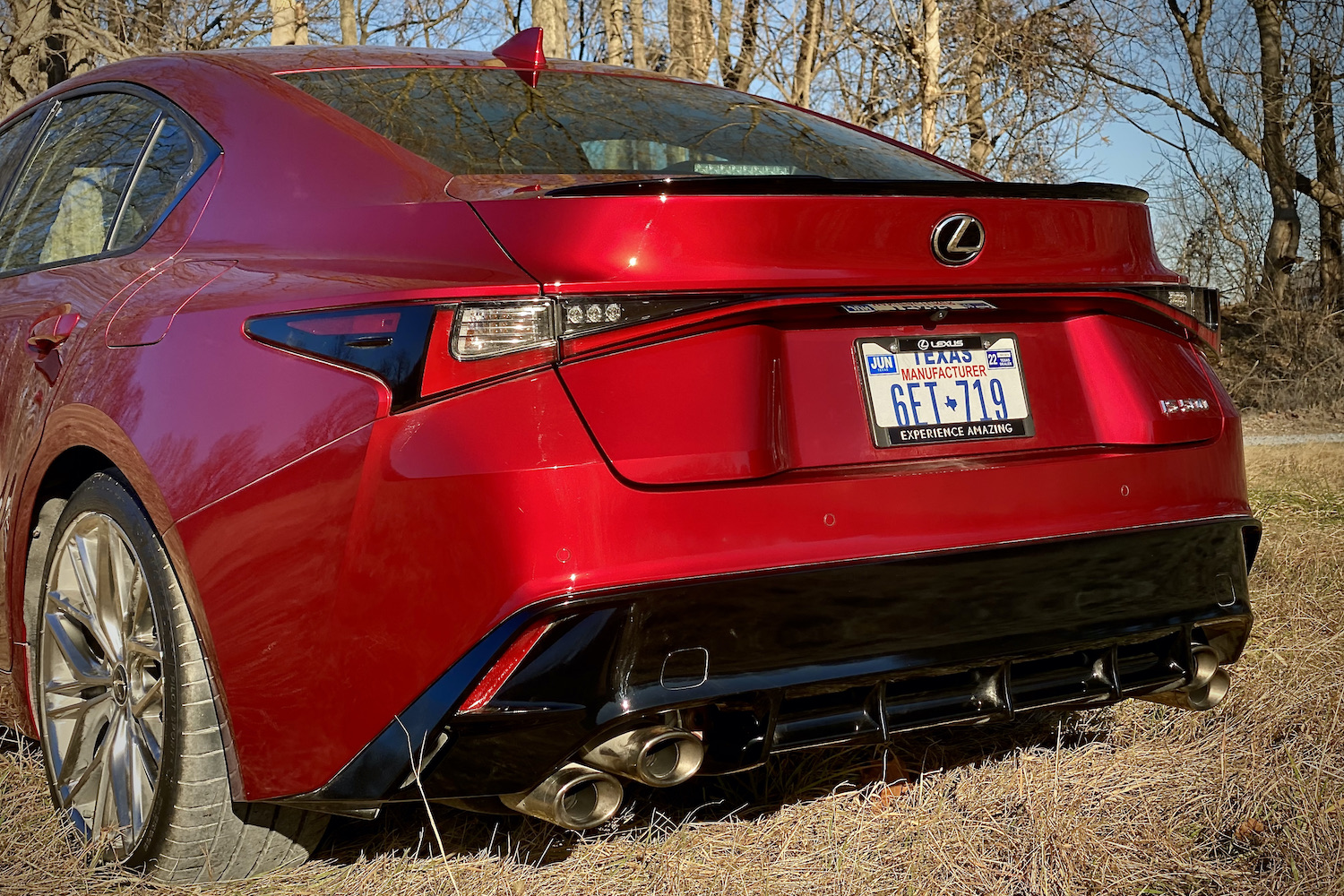 Lexus IS 500 rear end close up angle from driver's side in a grassy field.