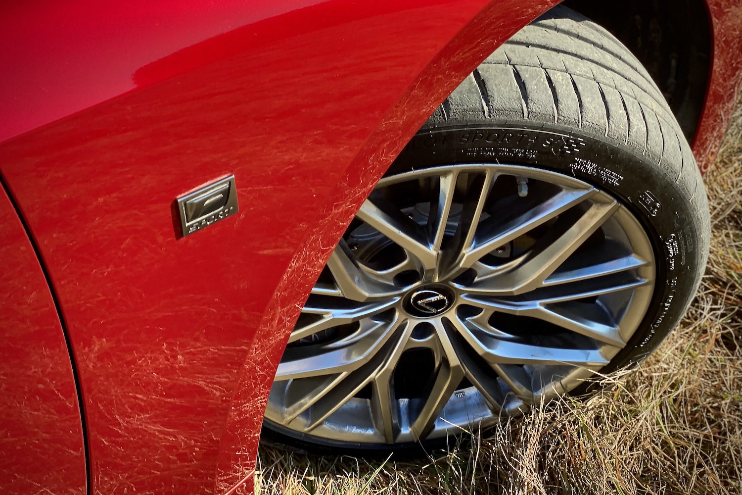 Close up of Lexus IS 500 front passenger's side tire from above.