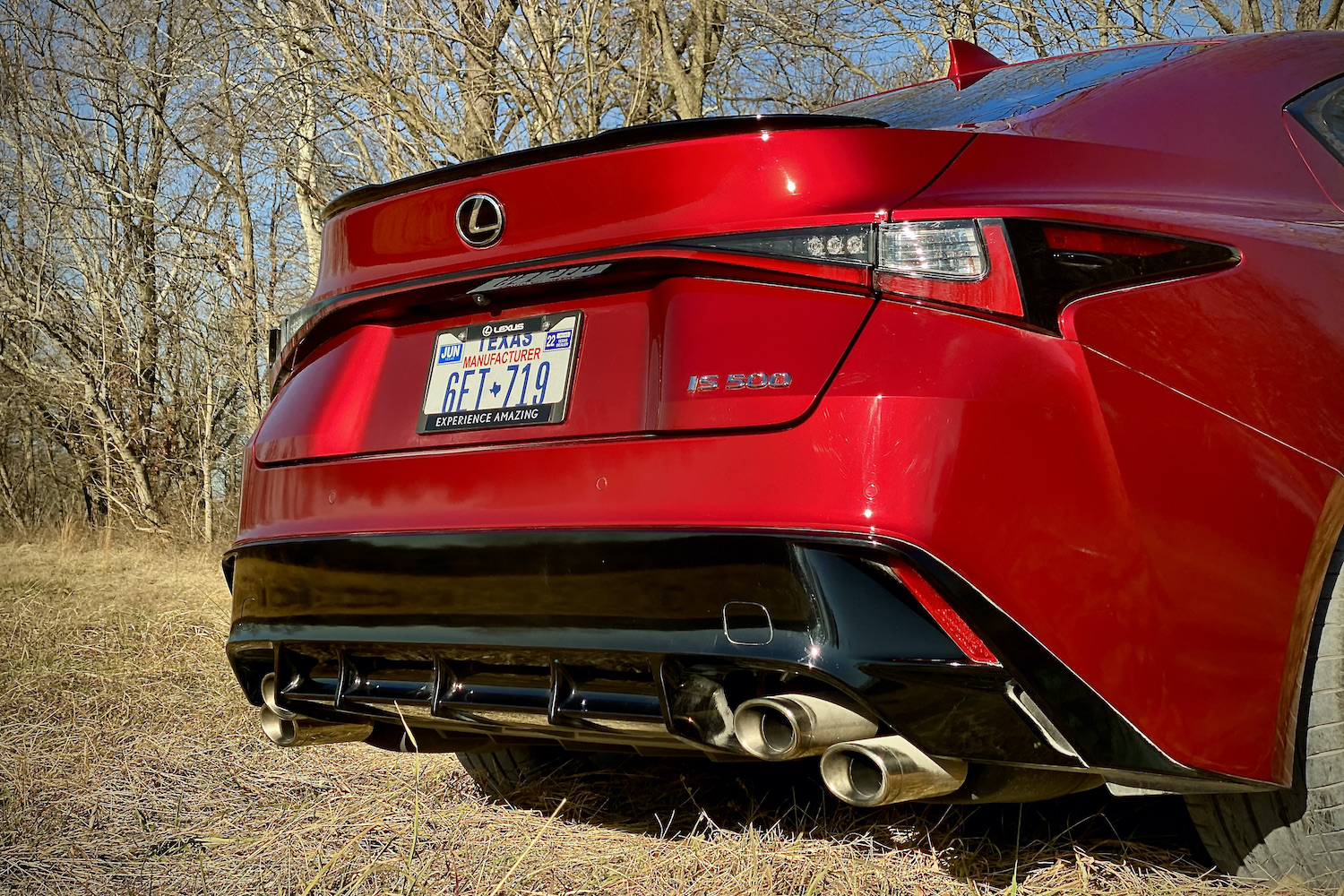 Lexus IS 500 rear end from passenger's side close up in a grassy field.