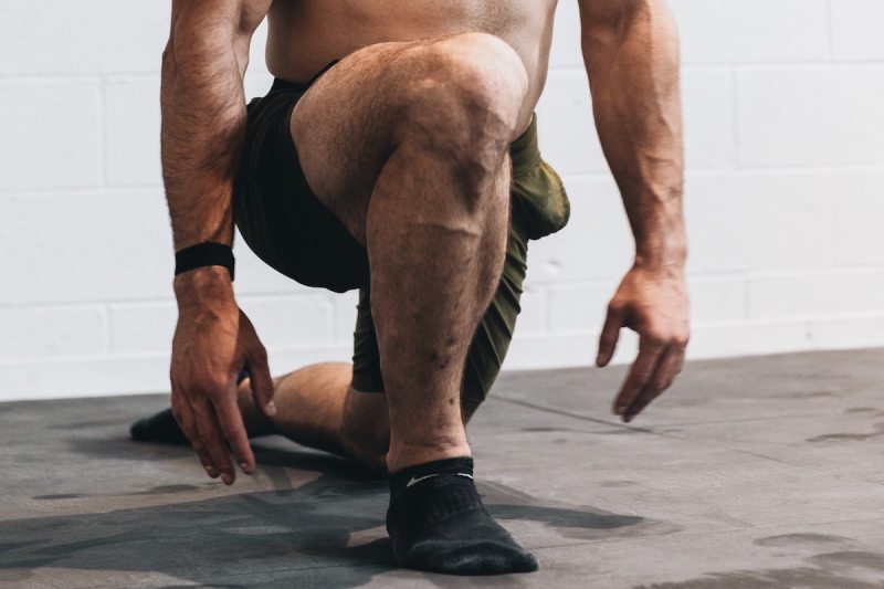 Man doing quad exercises at home.