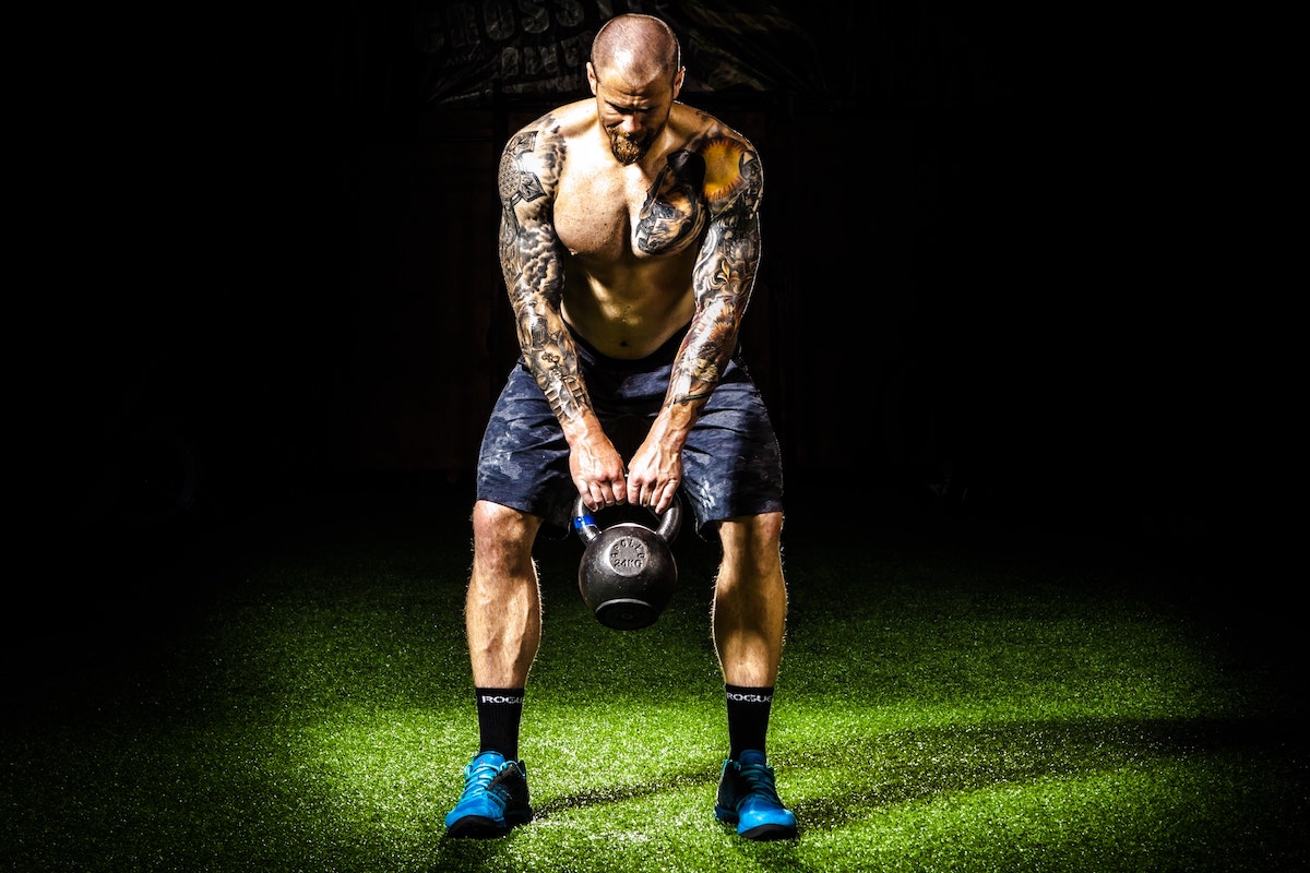 man doing kettlebell swings.