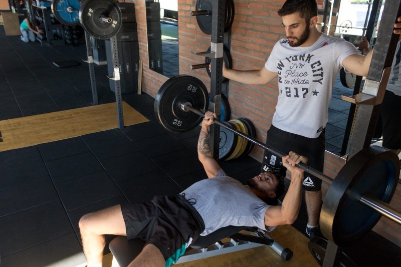 lifting weights with spotter.