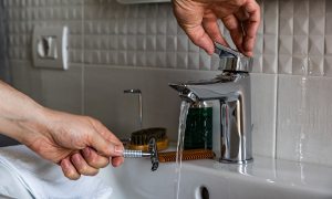 Razor being rinsed under water.