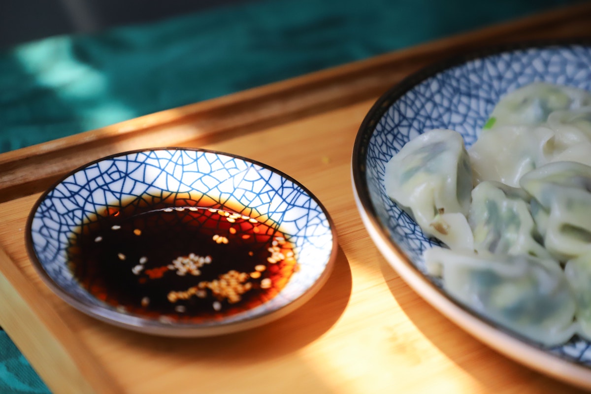 Soy sauce next to a plate of food