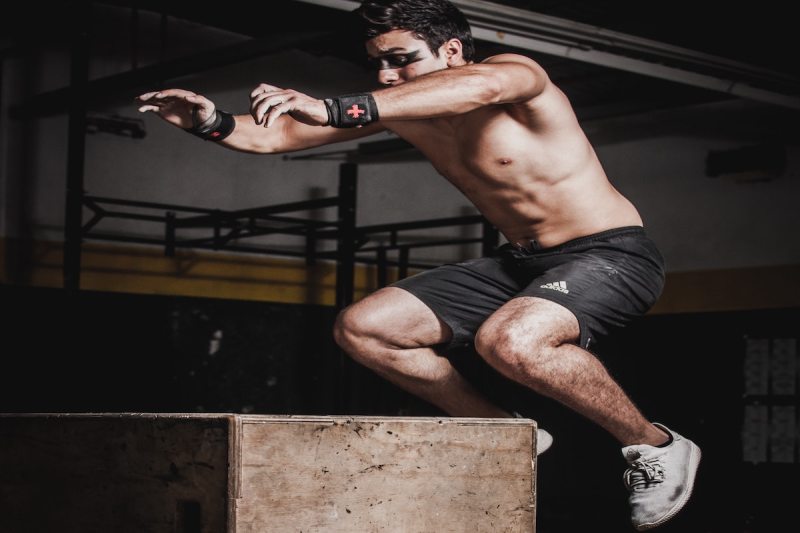 Man doing plyometric box jump