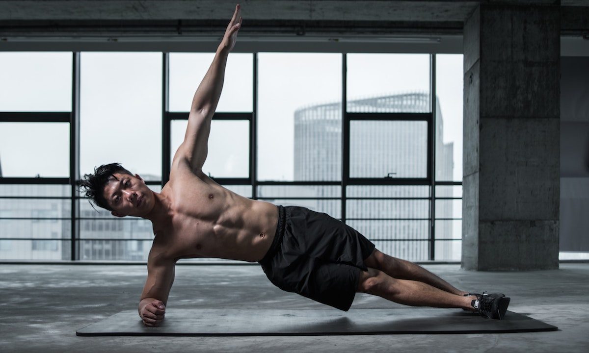 Man doing side plank.
