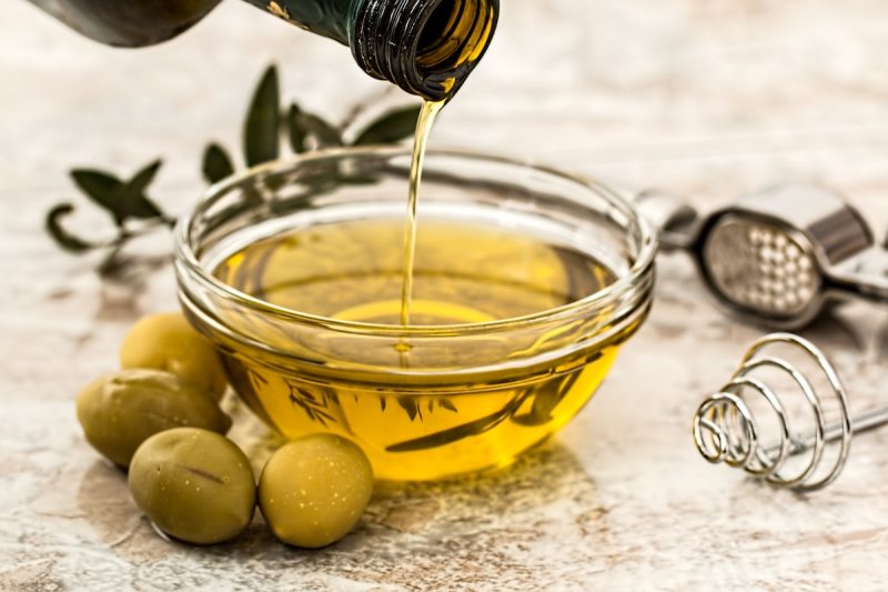 Olive oil being poured into a bowl.