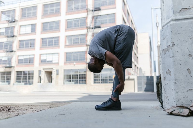 man stretching his hamstrings.