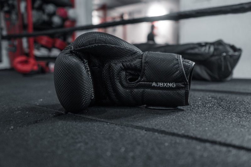 Boxing gloves sitting on the floor of the boxing ring.