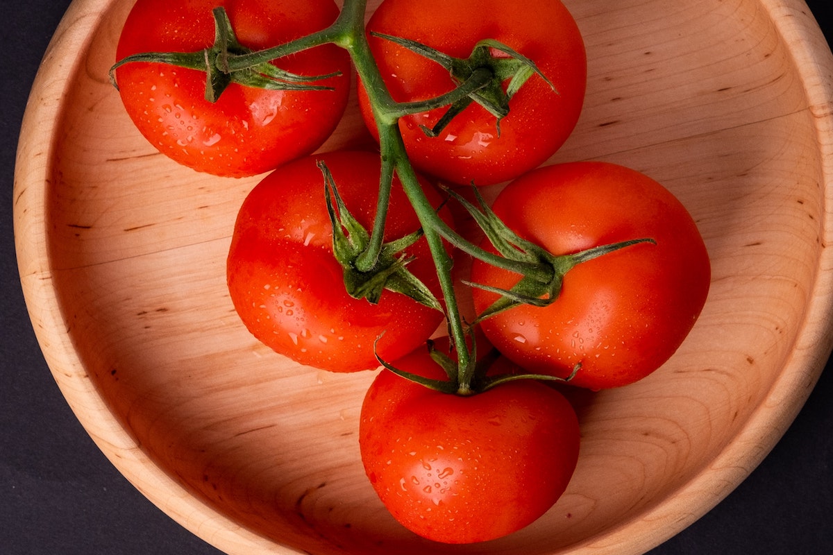 Tomatoes on vine in a bowl